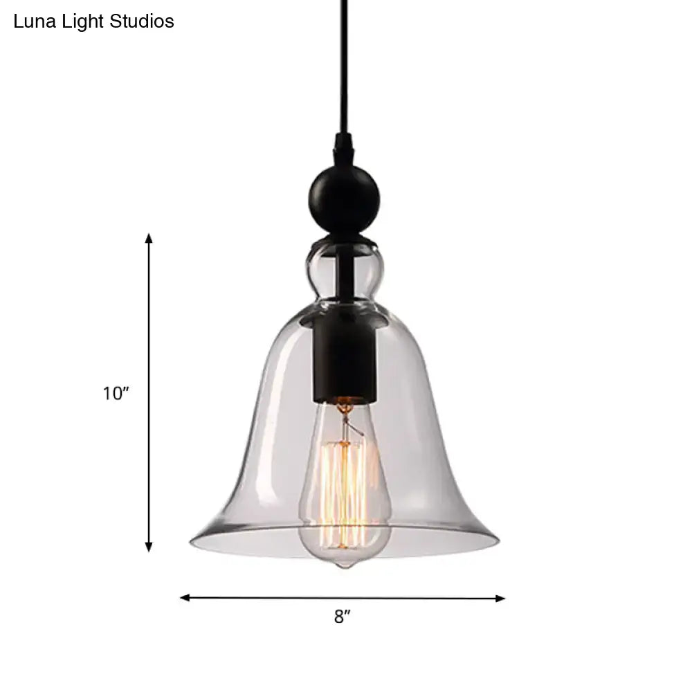 Clear glass bell-shaped pendant lamp with black metal fixture and exposed edison bulb in aldhibah black rustic style