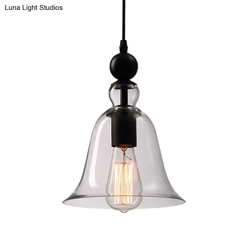 Clear glass bell-shaped pendant lamp with black metal fixture and exposed bulb in DecorBites™ aldhibah black rustic style