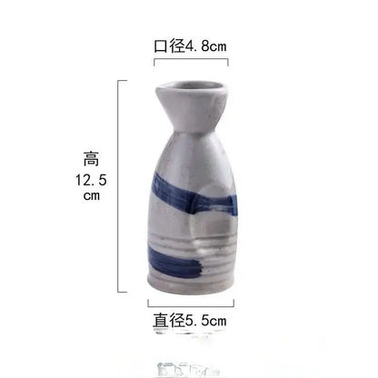 A small white ceramic wine sake bottle with bold blue brushstrokes from decorbites ceramic wine sake set
