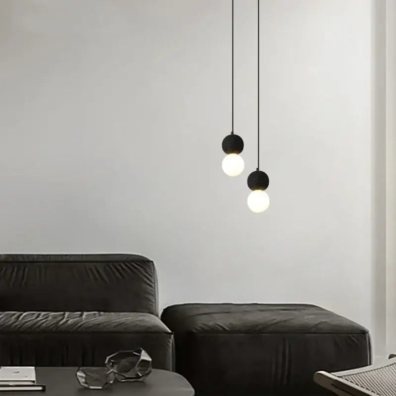 Black travertine led pendant light with spherical frosted glass bulbs hanging from thin cords for dining room decorbites black travertine