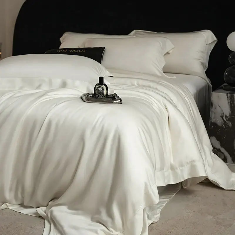 Cream-colored satin duvet cover set with matching pillowcases made of lyocell eucalyptus fiber for luxury bedding set