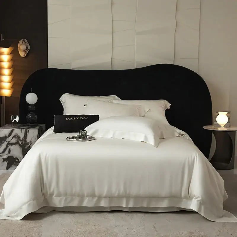 Black velvet headboard with sleek curved design complements luxury soft bedding set made from lyocell eucalyptus fiber