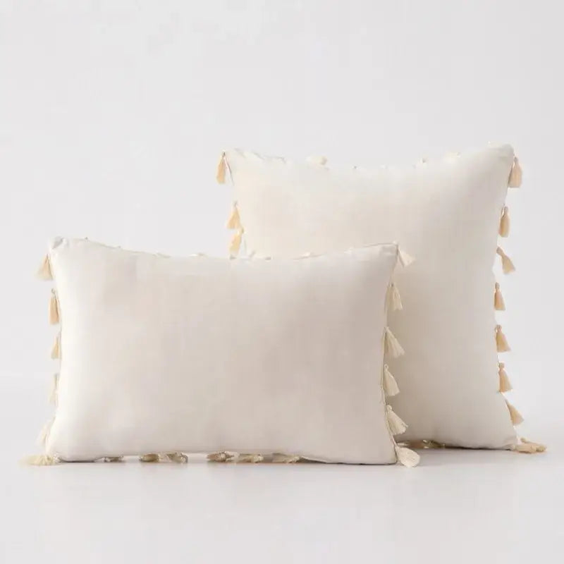 Cream-colored rectangular pillow cover with soft tassel fringe trim for decorbites black velvet living room sofa decor