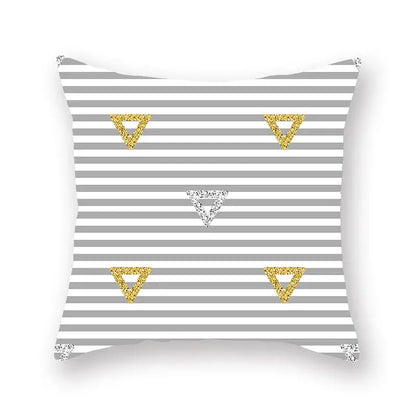 A square throw pillow with a gray and white geometric star stripe pattern and glittery gold and silver accents