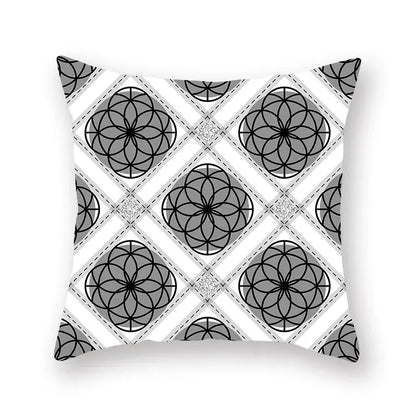 Square throw pillow featuring a black white and gold geometric star stripe print with intersecting circles and diamond shapes