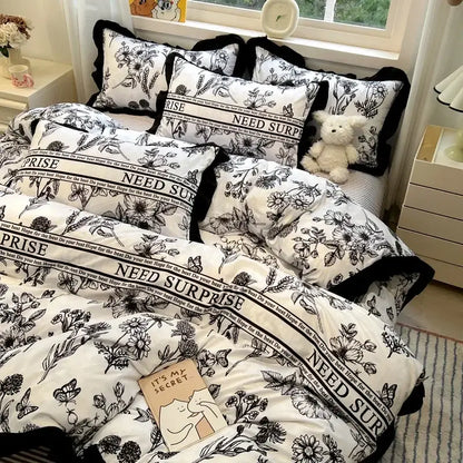 Black white printed floral bedding set with bold black trim featuring ruffled decorbites black white bedroom linens