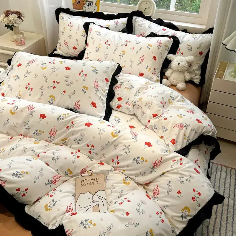 Floral-patterned black white printed bedding set with red yellow green flowers and black ruffled edges by decorbites black white