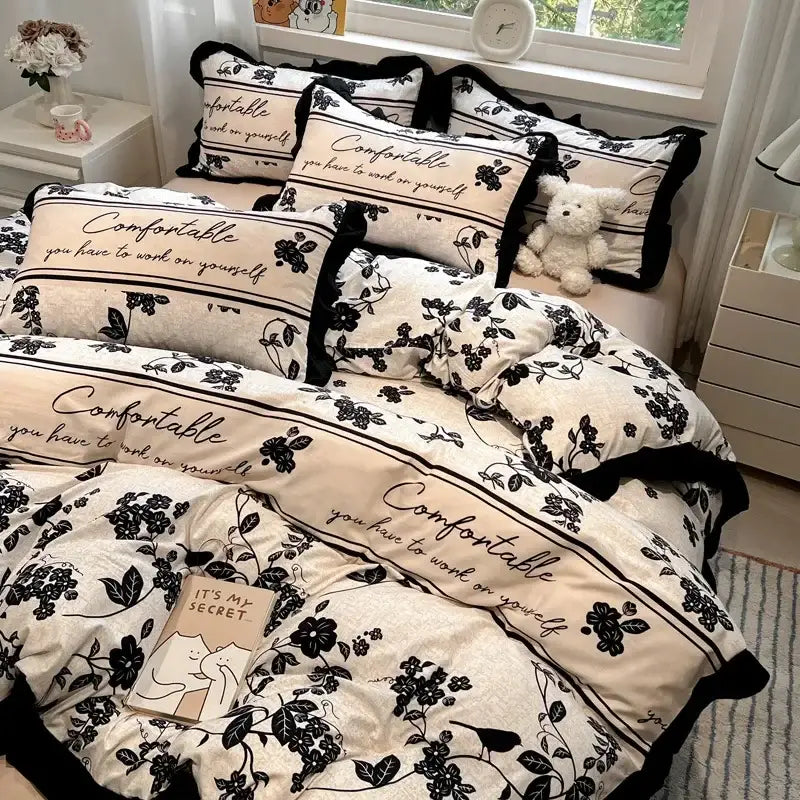 Cream-colored cream black white printed bedding set with floral and script patterns and ruffled edges by decorbites black white