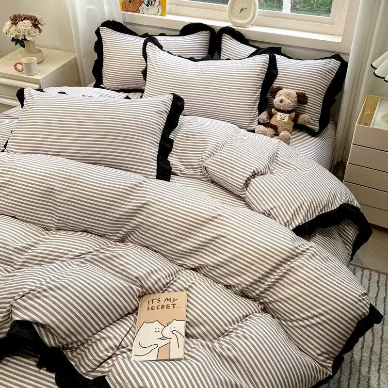 Striped bedding set with black white printed floral design ruffled edges and cozy plush texture by decorbites black white