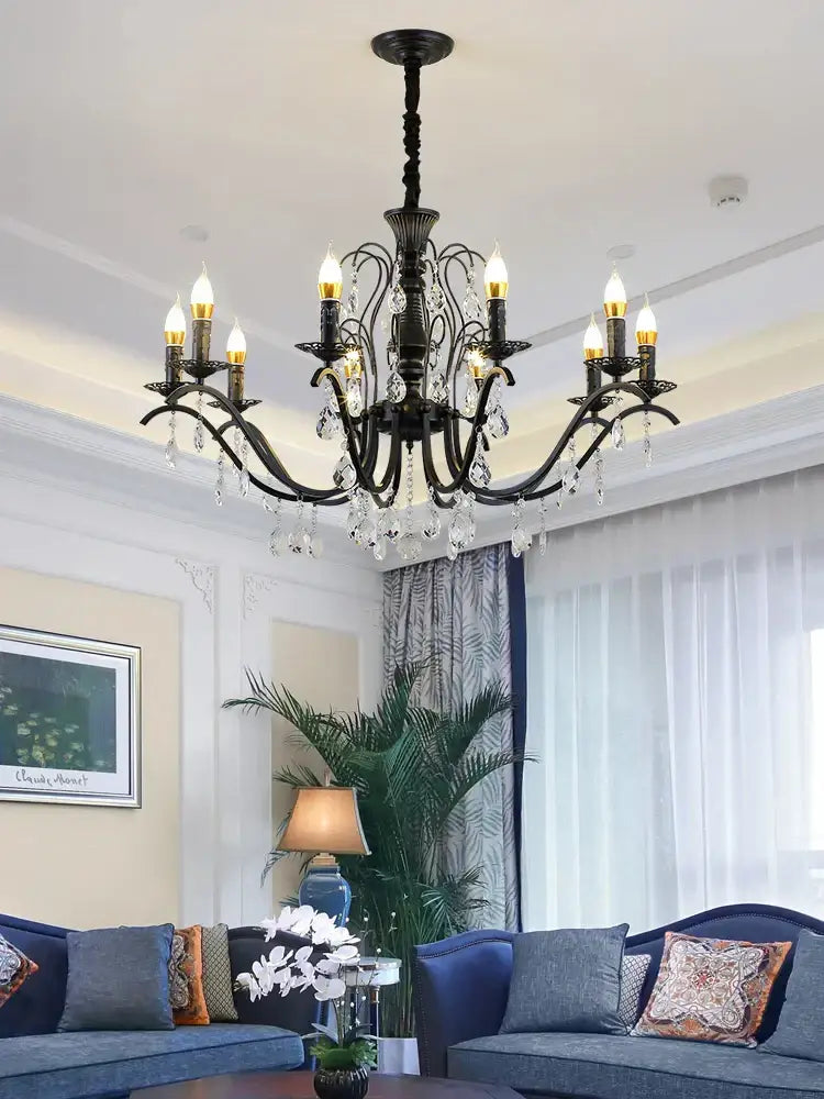 Black wrought iron chandelier with crystal droplets and candle-style bulbs ideal for dining room lighting