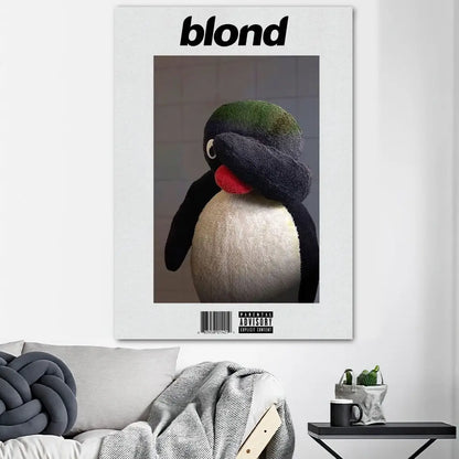White framed poster print featuring plush black and white penguin with green tuft for home decor oceans poster prints