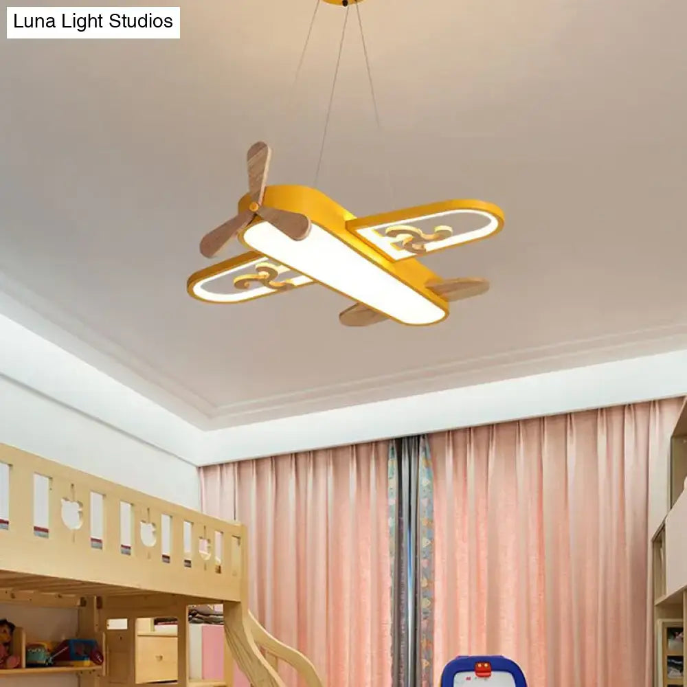 Yellow airplane-shaped pendant light with wooden propeller and decorative swirls as perfect addition with control stepless dimming