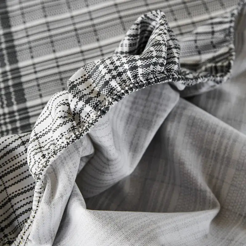 A soft textured black and white geometric fabric on a decorbites coarse cotton queen fitted sheet for bedroom use