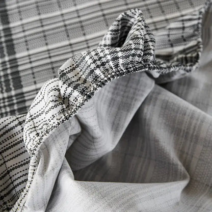 A soft textured black and white geometric fabric on a decorbites coarse cotton queen fitted sheet for bedroom use