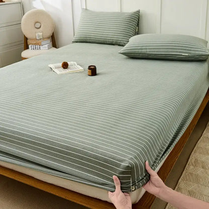 A soft sage green fitted sheet with delicate white stripes made from decorbites coarse cotton queen fabric