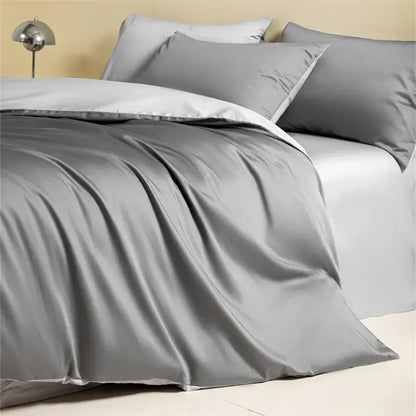 Gray satin duvet cover set with matching pillows in a blue and beige egyptian cotton bedding set for bedroom