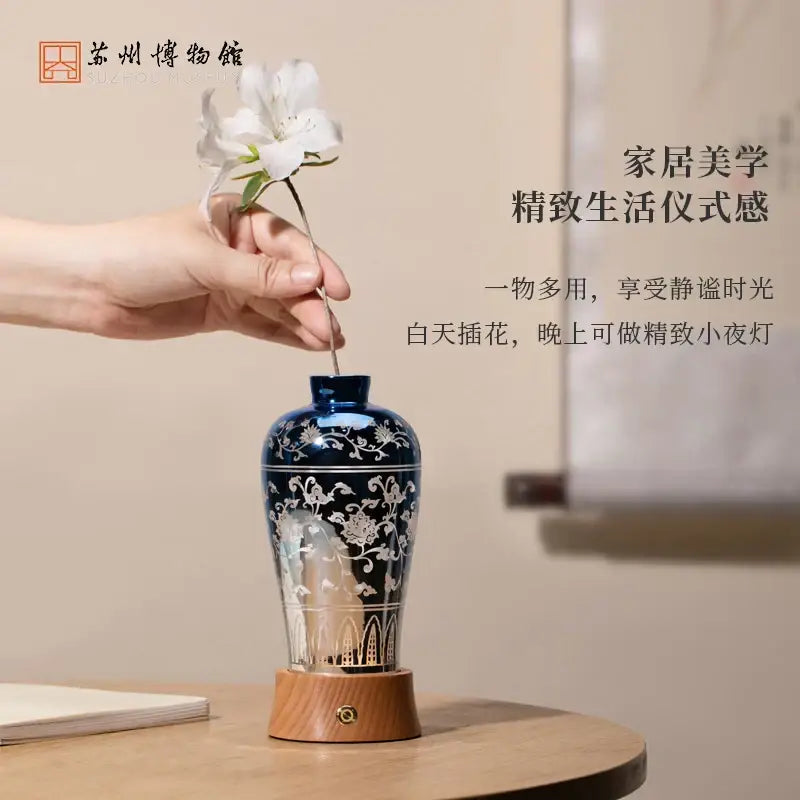 Deep blue ceramic night light table lamp with white floral patterns wooden base and brass accent by decorbites liuguang qingying