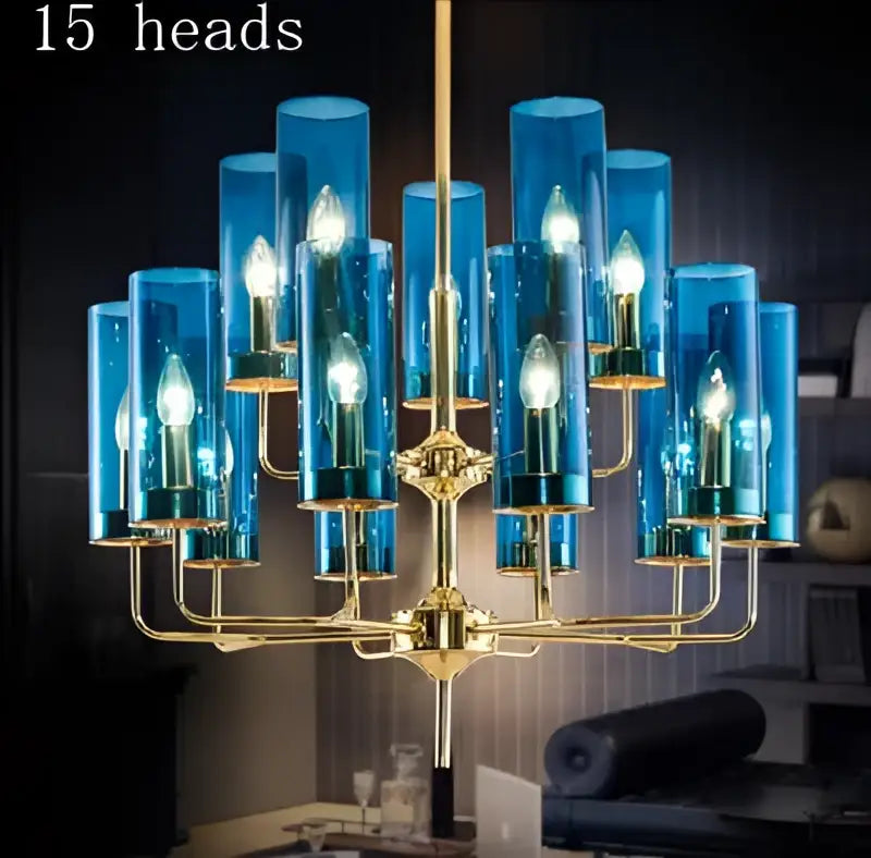 Blue and gold Decorbites glass chandelier with fifteen illuminated candle-style bulbs for kitchen island lighting