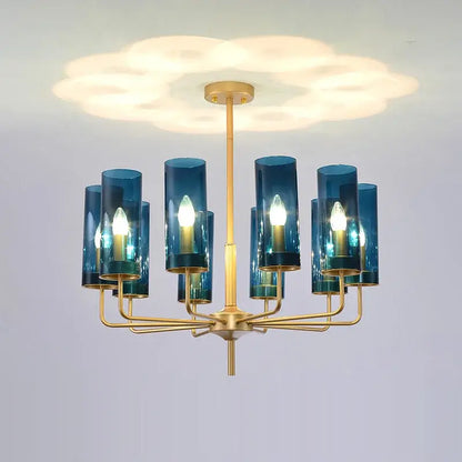 Blue and gold decorbites glass chandelier with blue glass cylinders and gold-toned metal for kitchen island lighting
