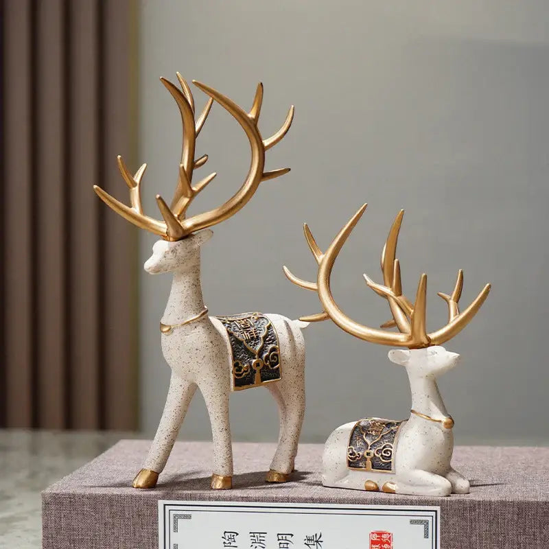 Two elegant ceramic elk reindeer decorbites deer figurine set with gold antlers and black and gold saddles for living room decor