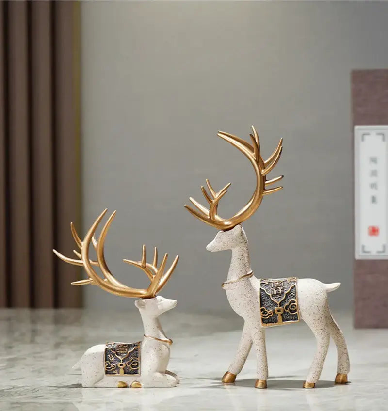 Two elegant ceramic elk reindeer decorbites deer figurine set with gold antlers and blue decorative saddle accents