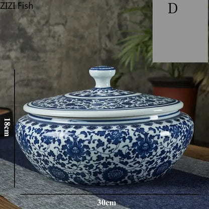 A classic blue and white floral ceramic tea caddy jar with a rounded body and matching lid for living room decor