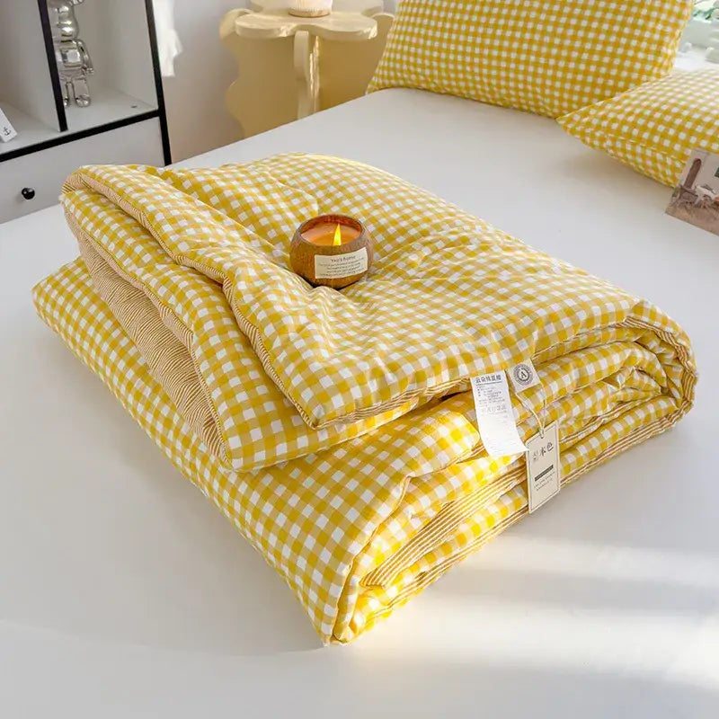 Yellow and white gingham patterned cotton summer quilt with soft plush texture for bedroom comforter use