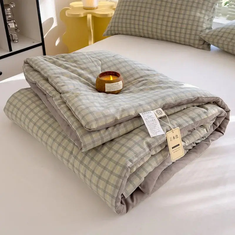 A soft cotton summer quilt with light green beige plaid pattern and gray inner lining featuring soybean fiber filling