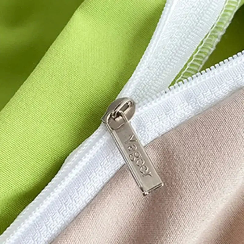 Silver metal zipper pull engraved vager on white zipper track of blue and yellow soft plush bedding set decorbites comfort king