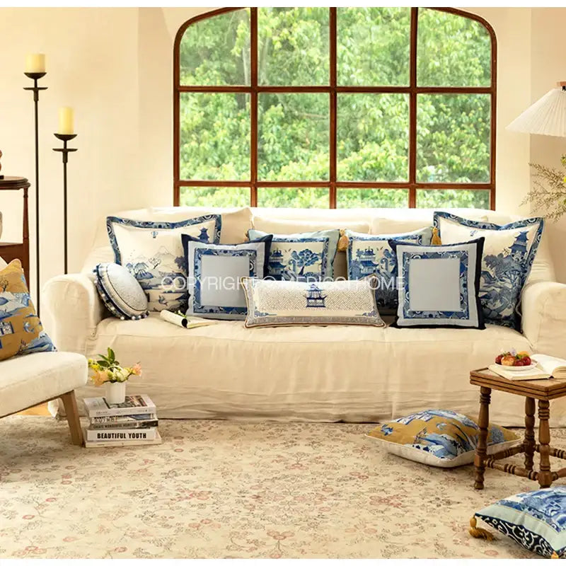 Cream-colored sofa with decorbites blue chinoiserie pagoda bolster pillowcase featuring traditional chinese designs