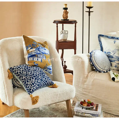 Blue chinoiserie home pagoda bolster pillowcase featuring a blue and white patterned throw pillow with gold tassels