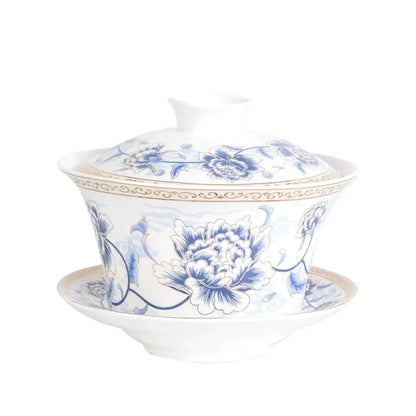 Blue floral white porcelain tea cup set with intricate peony patterns and gold trim for elegant dining room use