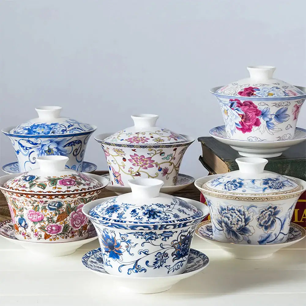 Blue floral white porcelain tea cup set featuring intricate pink and gold patterns for elegant dining room use