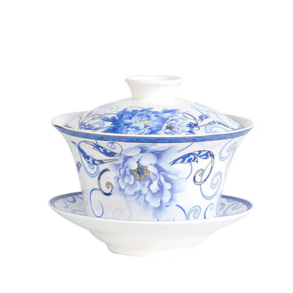 A white porcelain tea cup set featuring a teapot with intricate blue floral peony patterns for dining room use