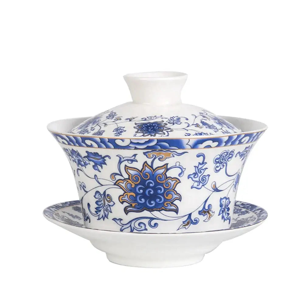Blue floral white porcelain tea cup set featuring intricate patterns and a central golden lotus for dining room use