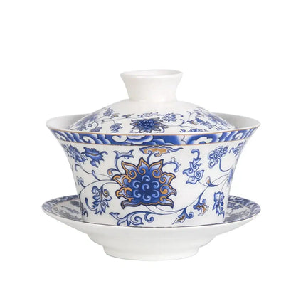 Blue floral white porcelain tea cup set featuring intricate patterns and a central golden lotus for dining room use