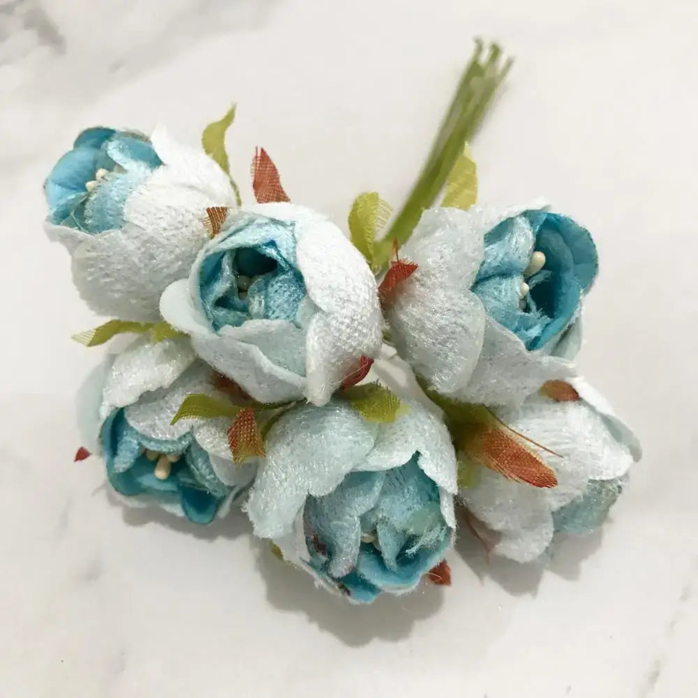 A delicately arranged decorbites blue flower cherry stamen berries bundle with white and light blue petals for living room decor