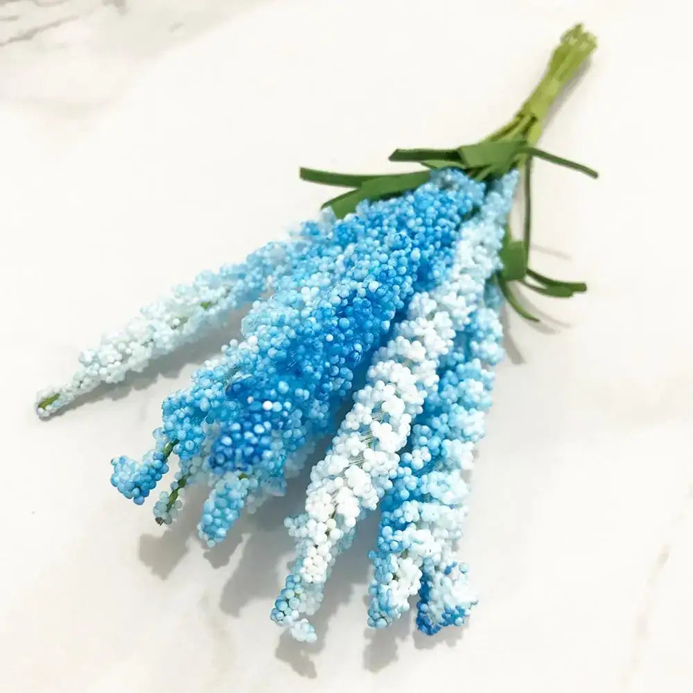 A delicate bouquet of decorbites blue flower cherry stamen berries in blue and white for living room decor