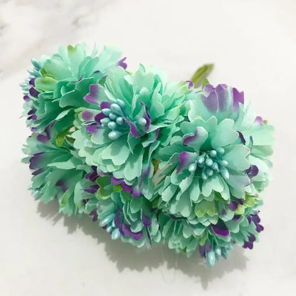 A bundle of decorbites blue flower cherry stamen artificial flowers with mint green petals edged in purple and light blue beads