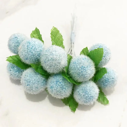 A cluster of light blue fuzzy fabric blue flower cherry stamen berries with green ribbon leaves for living room decorbites decor