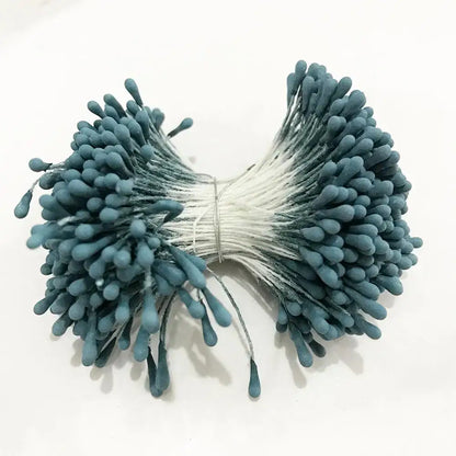 A bundle of teal fuzzy-tipped blue flower cherry stamen berries with white stems for decorbites blue flower decor