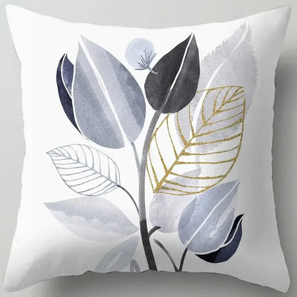 White throw pillow with a blue flower leaves pattern featuring modern watercolor gray black and gold decorbites blue flower design