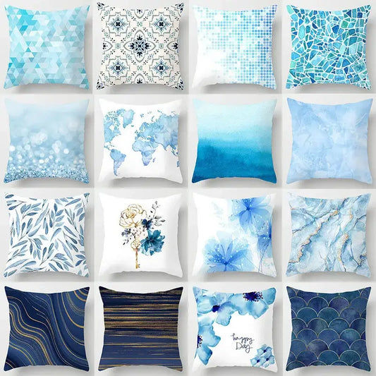 A collection of blue geometric marble throw pillows with various patterns including maps and floral motifs for living room decor