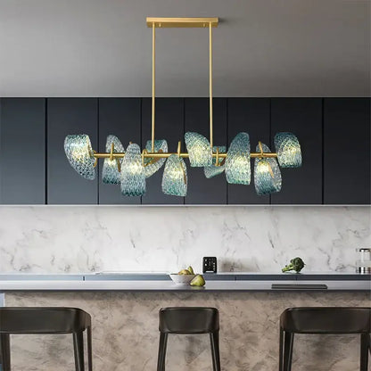 A modern blue glass flower ceiling chandelier with gold-toned metal frame and textured blue glass shades for dining room decorbites blue glass