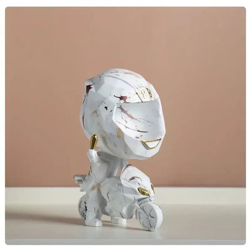 White marble-effect motorcycle rider figurine with gold accents and stylized helmet for decorbites decorative key storage