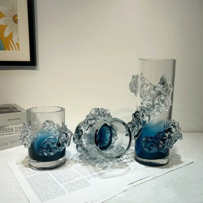 Clear glass vase with intricate sculpted wave-like embellishments and a blue gradient wavy interior for living room decor