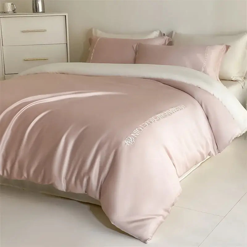 A blush pink satin duvet cover and pillowcases with subtle white embroidery in decorbites cotton solid color bedding set