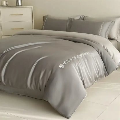 Gray satin duvet cover with white embroidered text and logo from decorbites cotton solid color bedding set