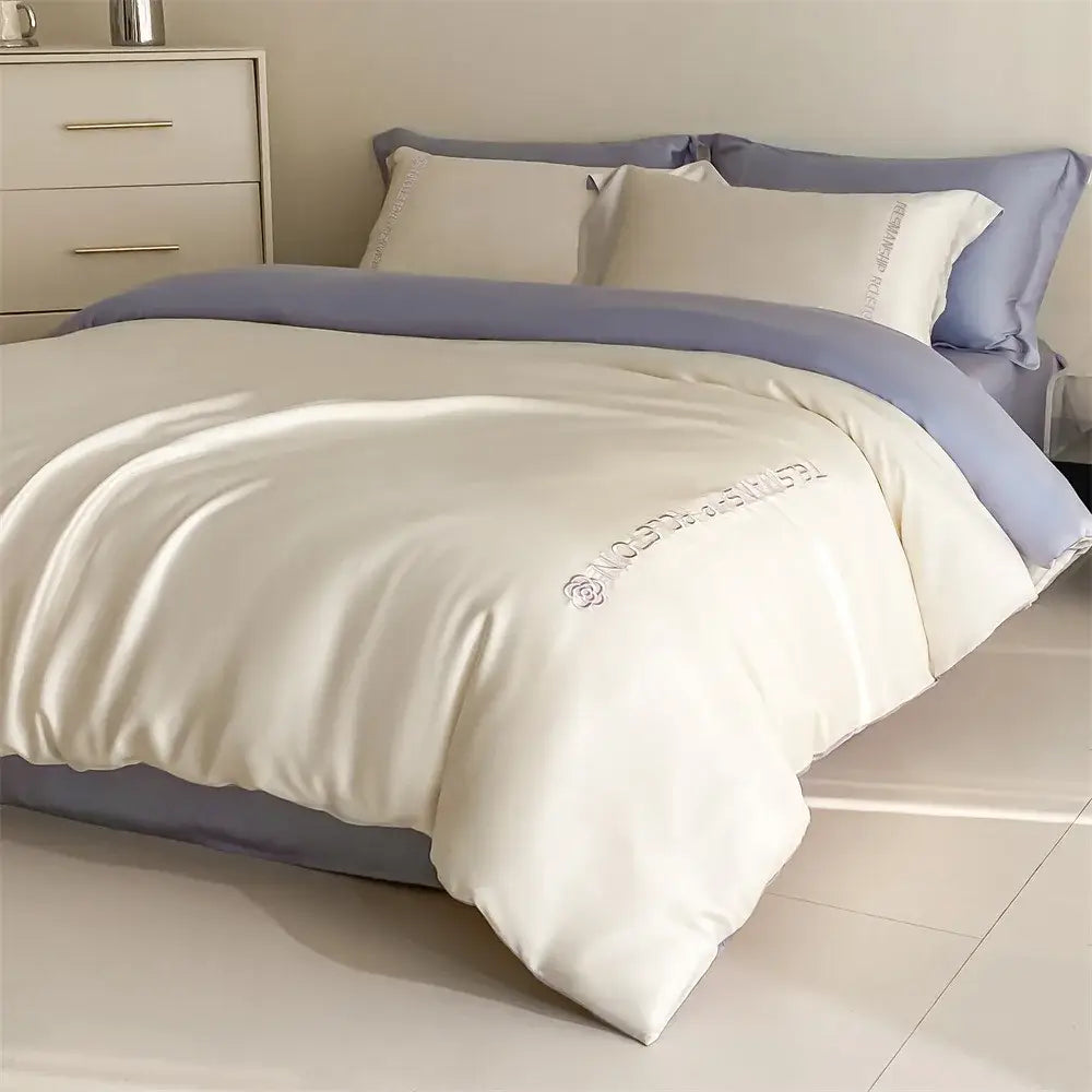Cream-colored satin duvet cover with lavender trim and embroidered rose logo in decorbites cotton solid color bedding set