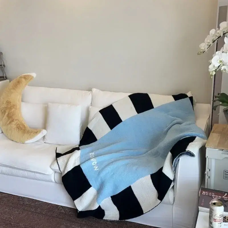 A soft light blue and black and white striped flannel sofa blanket from decorbites cozy perfect for bedroom decor
